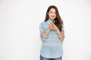 Asian woman in jeans shirt smiling and holding grocery basket isolated on white background, Shopping and Supermarket concept - 774191681