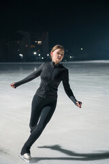 Beautiful young woman ice skating