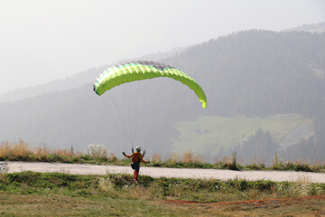 paraglider catching the wind in his parachute ready for take off