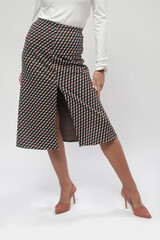 Serie of studio photos of female model wearing viscose fitted white shirt and patterned midi skirt...