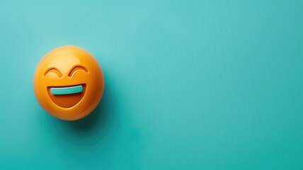 A bright yellow laughing emoji ball on a turquoise background