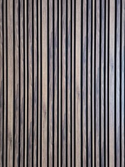 Wooden stripes on a black wall

