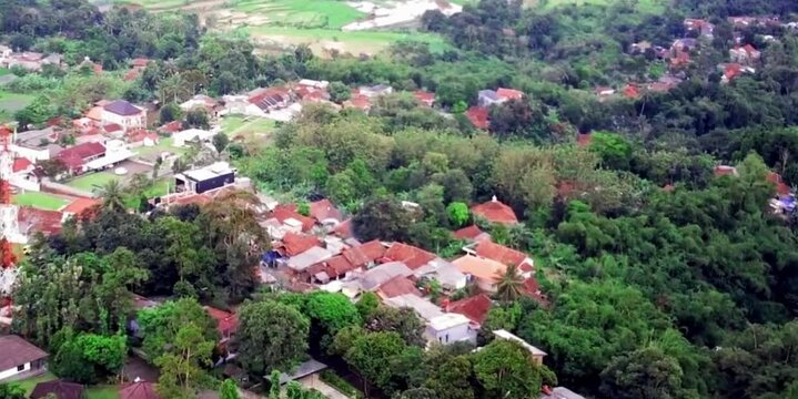 aerial video depicting a population that is not yet dense in a village on a mountain slope with relatively quiet traffic and unspoiled natural scenery