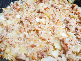 Stuffing with onions. Ground meat and onions cooking in a frying pan.