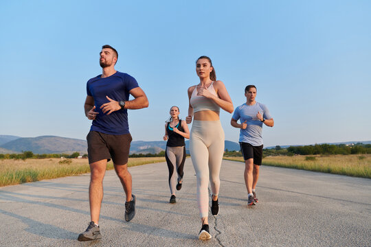 A group of friends maintains a healthy lifestyle by running outdoors on a sunny day, bonding over fitness and enjoying the energizing effects of exercise and nature