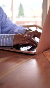 person working on laptop, woman working from home typing on her laptop, vertical video