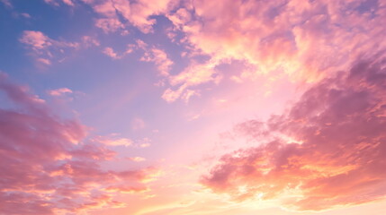Pink and orange clouds illuminated by the setting sun against a soft blue sky - obrazy, fototapety, plakaty