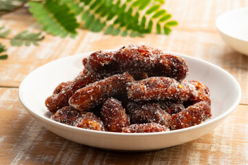 Sweet tamarind mix with sugar and chilli in white plate.
