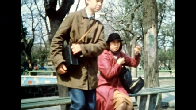 Angry mother scolding adult son on city street. Strict parent raising child in park. Offended teenage boy. Family scolding. Sad person. Archival vintage color film. Old retro archive. 1980s Crimea
