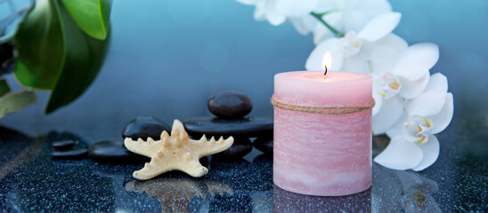 Spa background with white orchid , candle and zen black stones on gray. - 774221662