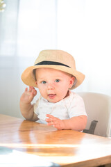 Baby boy sitting in high chair ready for eating