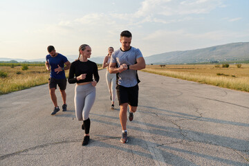 A group of friends maintains a healthy lifestyle by running outdoors on a sunny day, bonding over fitness and enjoying the energizing effects of exercise and nature - 774230283