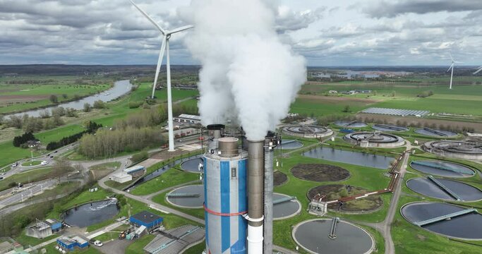 Aerial drone view on the smoke stack of a waste incineration plant. Smoke coming out of industrial waste processing plant. Duiven , The Netherlands.