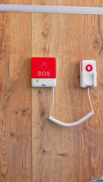 Emergency SOS button on the wall near the bed in postpartum intensive care unit. Close up. Equipment in maternity hospital. Vertical video