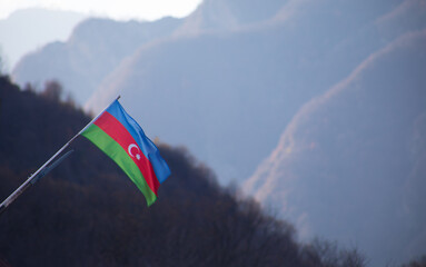 Azerbaijan flag,Waving flag on the mountain. National flag of Azerbaijan on strong wind in the sunny day.