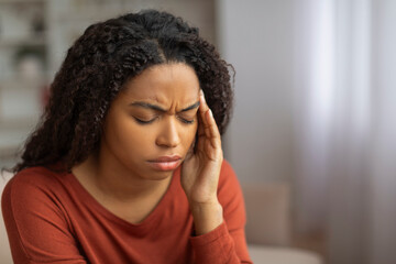 Fototapeta na wymiar Black Woman Experiencing Headache at Home