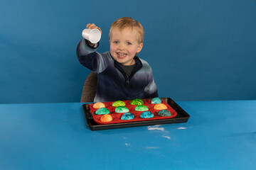 toddler boy makes fizzy dyed easter eggs with baking soda and vinegar for fun stem science...