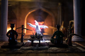Exquisite Arabian Interior: Realistic Miniature Depicting Table Decorations and a Swirling Dervish. Experience the Cozy Atmosphere of an Ancient Eastern-style Entertainment Venue.