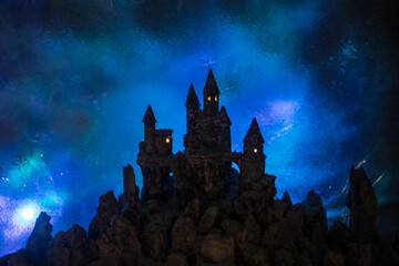 scary and mystic castle view on moonlight. Decorative table miniature.