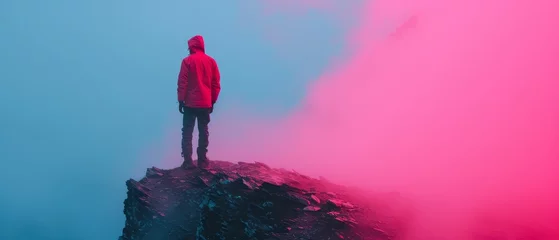 Foto op Plexiglas anti-reflex   A man silhouetted against a red-blue foggy sky, atop a mountain, facing reverse-camera direction © Jevjenijs