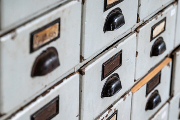 a bunch of drawers containing drawers with labels on them are stacked and locked