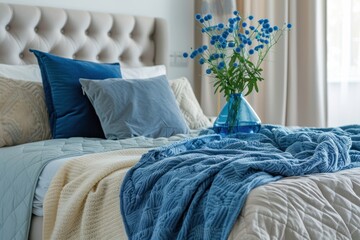Modern bedroom, bed with blue blankets and blue pillows, close up