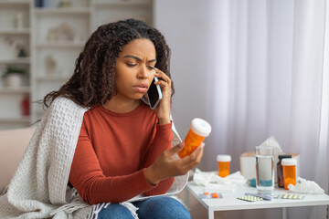 Young Black Woman Consulting With Doctor Over Phone Regarding Medication