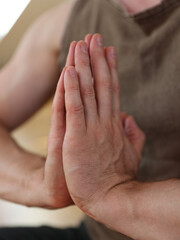 Yoga Man Sitting in Lotus Position and with Namaste Gesture close up. Prayer mudra. Open Heart Meditation, Gratitude concept