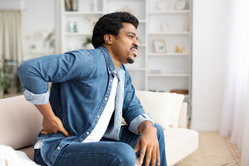 Black Man Experiencing Lower Back Pain at Home
