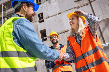 Contractor. construction worker team hands shaking after plan project contract  at construction site, contractor, engineering, partnership, construction concept