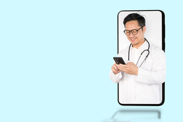 A doctor is looking at his cell phone. The image is a projection of a cell phone.