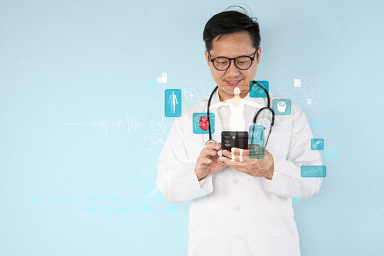 A man in a white lab coat is looking at his cell phone. The phone screen is filled with various medical icons.