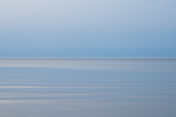 Loksa Estonia - March 31 2024: Mesmerizing dawn, where sea meets sky in perfect harmony, blending...