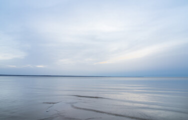 Loksa Estonia - March 31 2024: Mesmerizing dawn, where sea meets sky in perfect harmony, blending into a tranquil horizon. Serene moment captured at the break of day Hara bay, Finnish Gulf, Baltic Sea