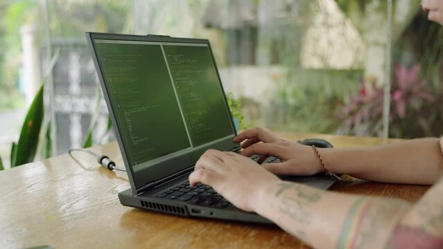 Software developer types code on laptop in natural light, fingers fly over keys, screen filled with programming syntax. Focus shifts subtly, outdoor coding scene, innovation at fingertips. Slowmo