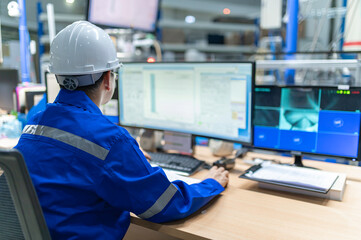 Naklejka premium Engineer working at control room,Manager control system,Technician man monitoring program from a lot of monitor