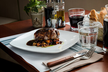 Hearty Breakfast: Boneless Pork Cheek with Red Wine Reduction Sauce and Assorted Mushrooms - Traditional Catalan Cuisine in a Rustic Restaurant Ambiance