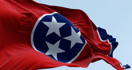 Close-up of the Tennessee state flag waving. Red field with a blue circle in the center containing three white stars. US state flag. 3d illustration render. Fluttering fabric - 774285868