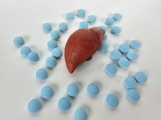 Liver problem with colorful medical pills closeup