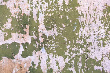 Worn out wall with peeling paint and faded colors.