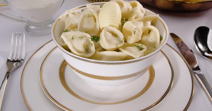 Dumplings in a plate with butter on the table, Uzbek Chuchvara - option 3