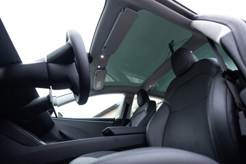 Panoramic glass sun roof in the new electric car. Clean glass and view from inside to the sky....
