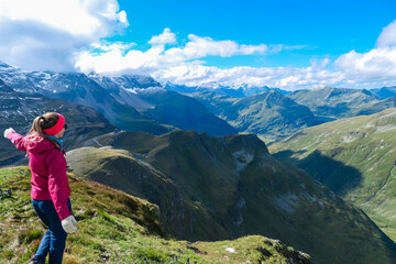 Hiker woman on top of mount Greilkopf with scenic view of majestic mountain peaks of Glocker group,...