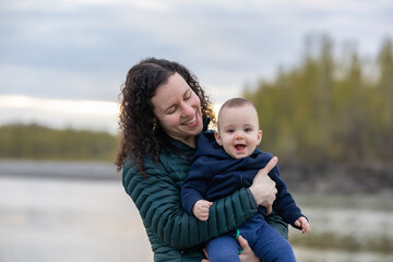 Mother and Baby Boy outside in nature by the river.