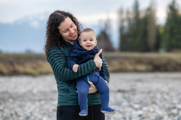 Mother and Baby Boy outside in nature by the river.