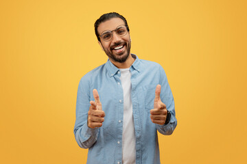 Man with direct camera gaze giving thumbs up