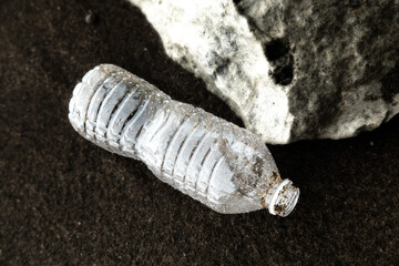 Plastic water bottle waste washed up on the beach causing pollution