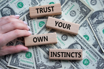 Trust your own Instincts symbol. Concept words Trust your own Instincts on wooden blocks. Beautiful...