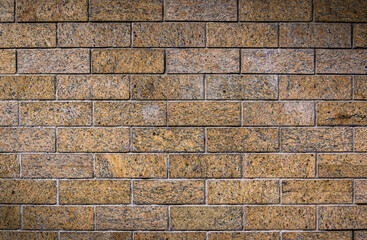 Old yellow brick wall background and texture