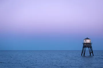 Wandcirkels aluminium Lighthouse in the sea, Dovercourt low lighthouse at high tide built in 1863 and discontinued in 1917 and restored in 1980 the 8 meter lighthouse is still a iconic sight after sunset © J.Woolley